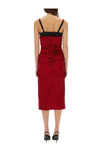 Dolce &amp; Gabbana women’s longuette dress in crimson satin with black straps and ruched back detail shown from the back