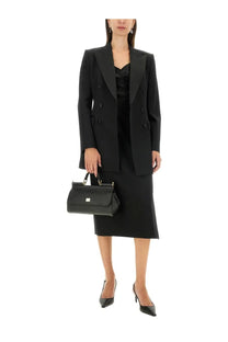 Black leather handbag with structured rectangular shape and top handle featured with dolce &amp; gabbana longuette skirt