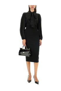 Black patent leather handbag with gold-tone hardware and structured rectangular shape for dolce gabbana women’s longuette skirt black