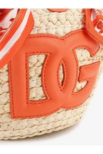 Bright orange leather dc logo patch on a woven straw dolce and gabbana maiolica shoulder bag in leather and raffia orange