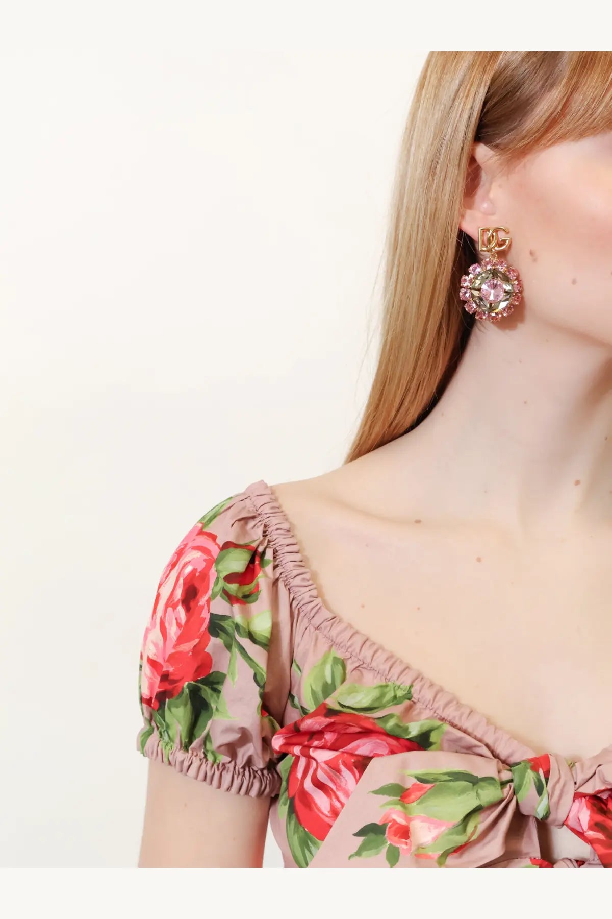 Gold-toned dolce &amp; gabbana brass earrings with a sparkling pink crystal centerpiece and ornate floral design