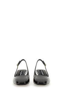 Dolce &amp; Gabbana women’s black patent leather slingback pumps with glossy finish and gold-tone buckle accents