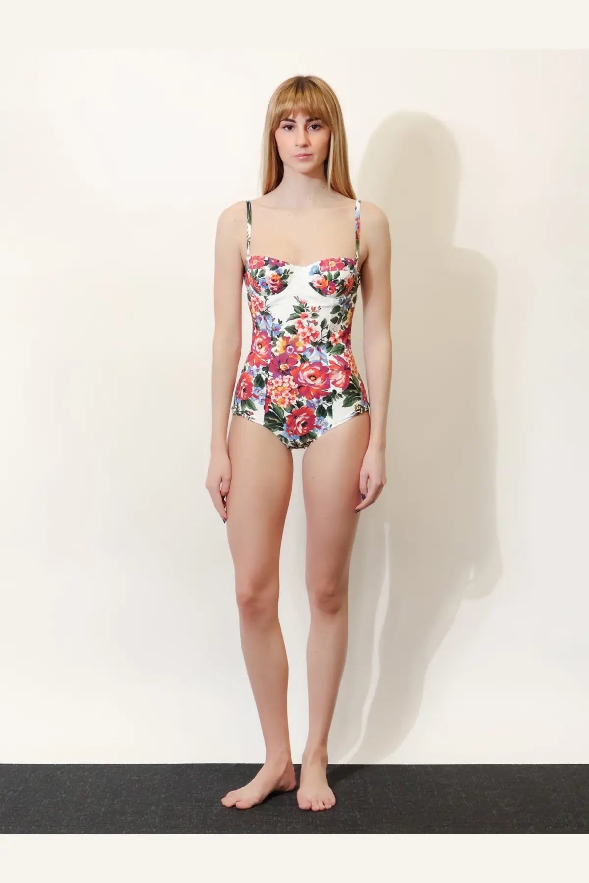 Dolce &amp; Gabbana women’s white one piece swimsuit with thin straps and vibrant red pink orange green floral pattern