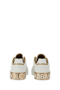 Dolce &amp; Gabbana women’s Portofino sneaker white leather with gold accents and bold lettering on the heel back side