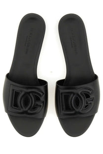 Dolce &amp; Gabbana women’s black slide sandals with glossy finish and embossed logo for stylish casual wear