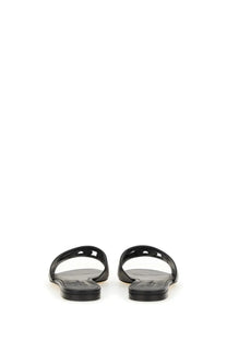 Dolce &amp; Gabbana women’s black leather slide sandals with minimalist design and cut-out details