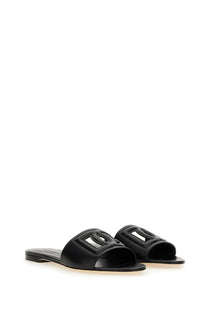 Dolce &amp; Gabbana women’s black leather slide sandals with a bold geometric logo design on the footbed