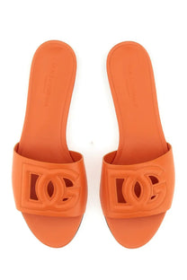 Dolce &amp; Gabbana women’s orange leather slide sandals with a prominent embossed dc logo on the strap