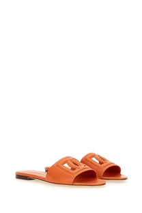 Dolce &amp; Gabbana women’s orange leather slide sandals with a distinctive cut-out logo design