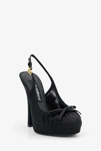 Dolce &amp; Gabbana women’s black satin slingback pump with gold-tone logo charm and bow detail at the toe