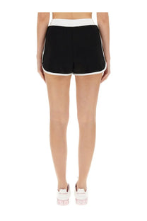 Dolce &amp; gabbana women’s black shorts with white trim and waistband featuring pink logo on the side