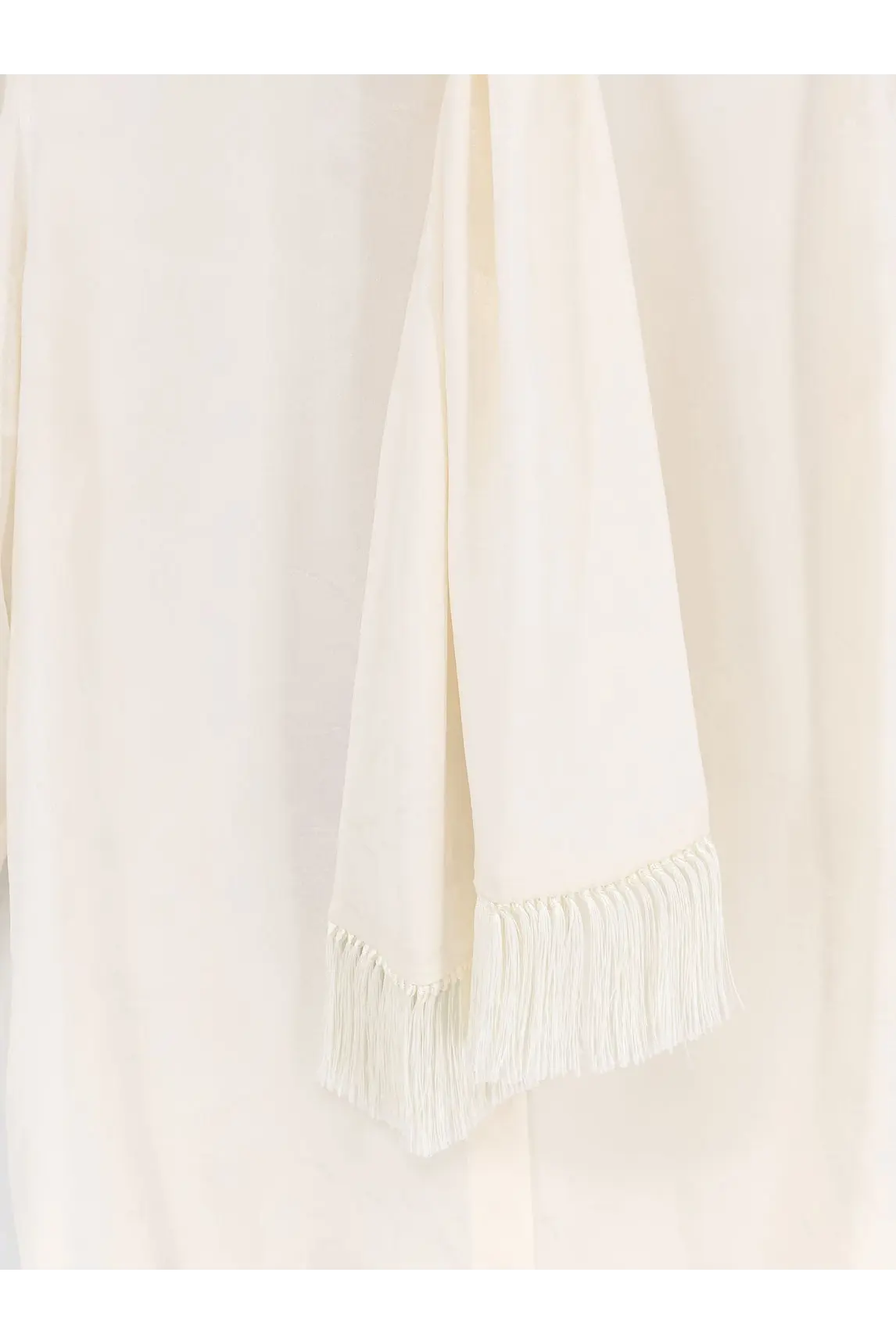 Cream-colored silk scarf with delicate fringe detailing paired with dolce and gabbana women’s white silk shirt
