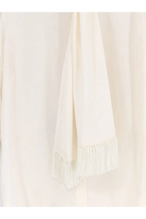 Cream-colored silk scarf with delicate fringe detailing paired with dolce and gabbana women’s white silk shirt