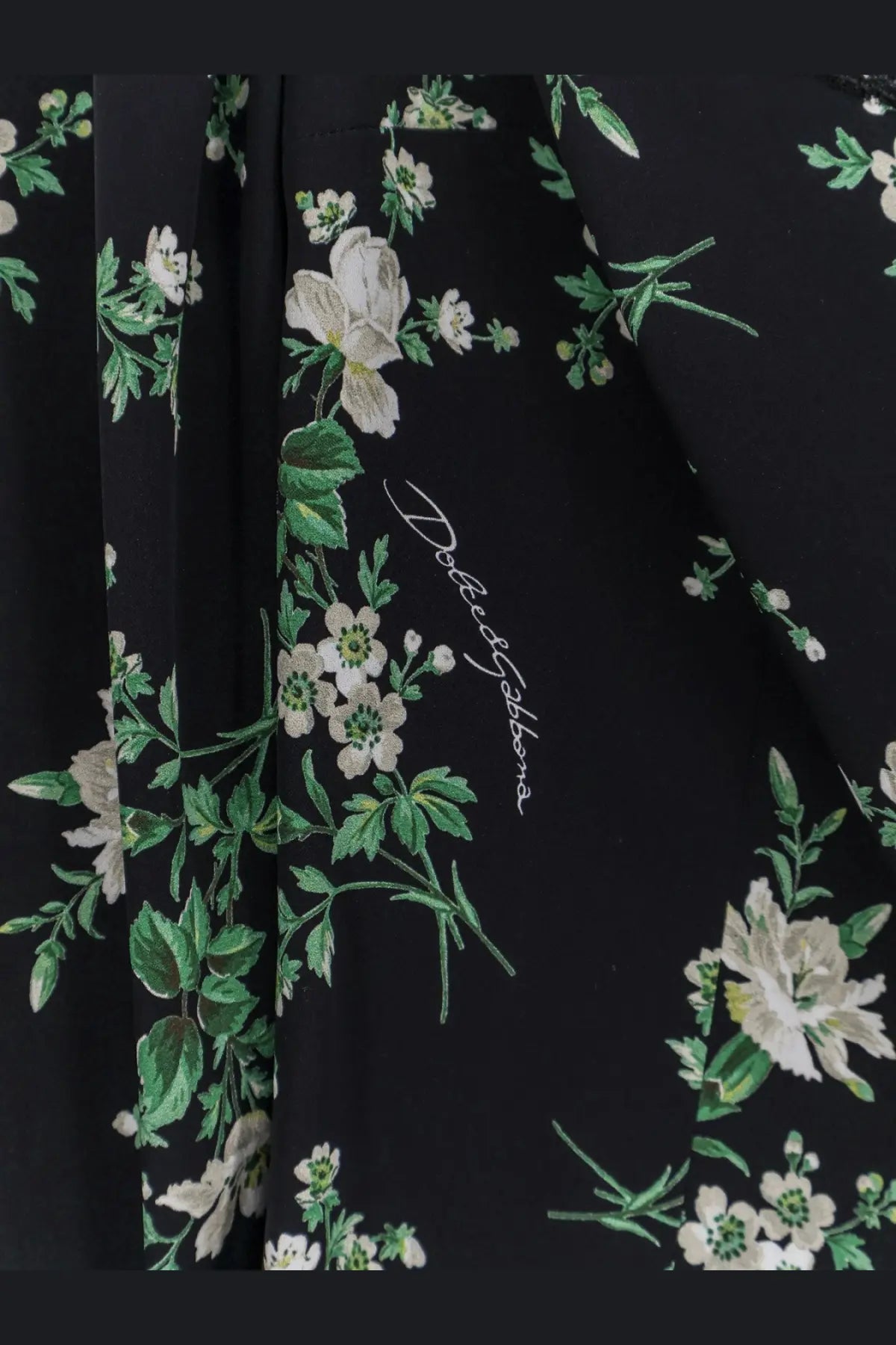 Dolce and Gabbana women’s black silk top with delicate white floral pattern and green leaves