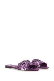 Dolce &amp; Gabbana women’s purple slide sandals featuring a paisley pattern and brand logo for casual wear