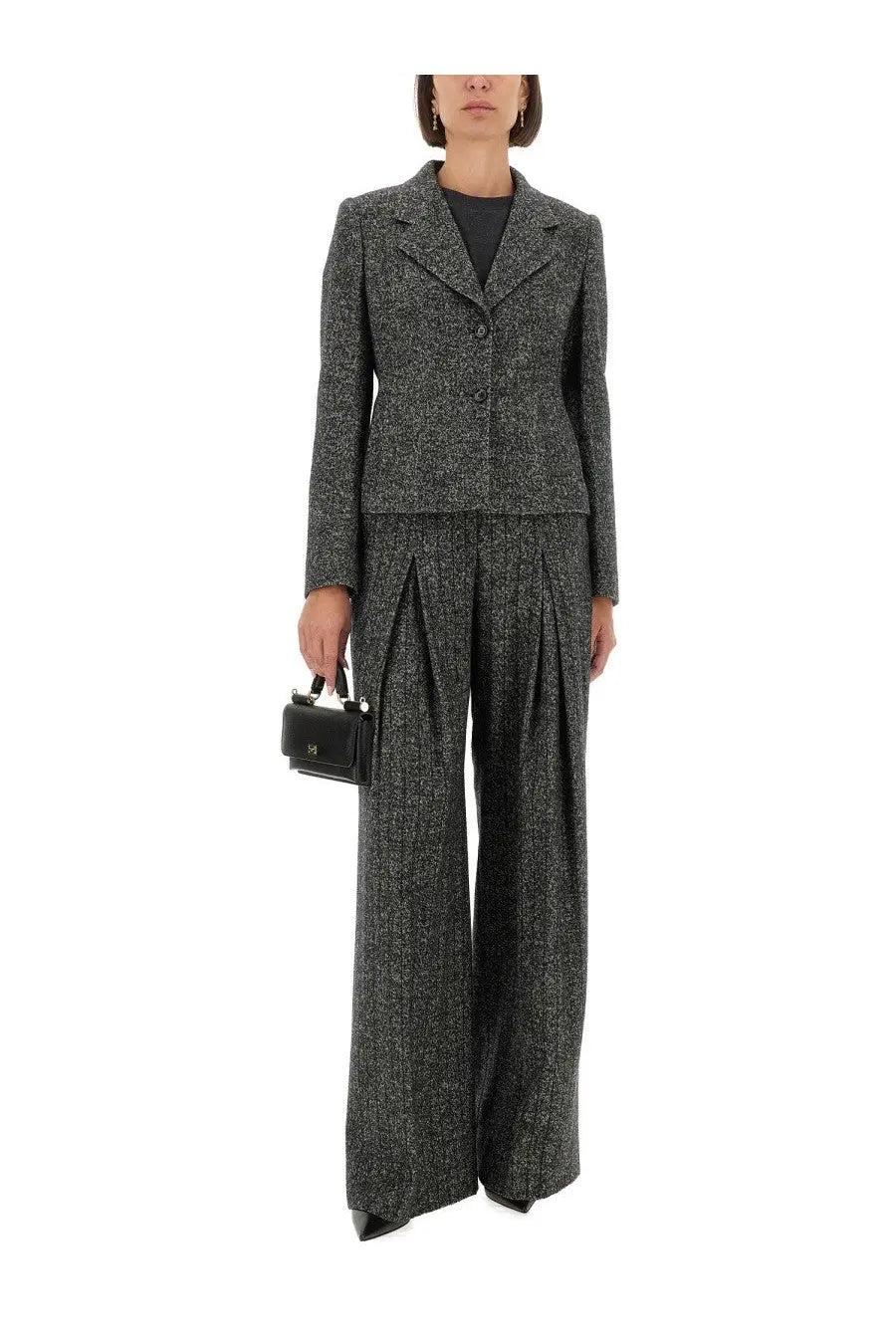 A black leather mini handbag with structured rectangular shape and silver toned hardware paired with dolce &amp; gabbana striped wool pants gray