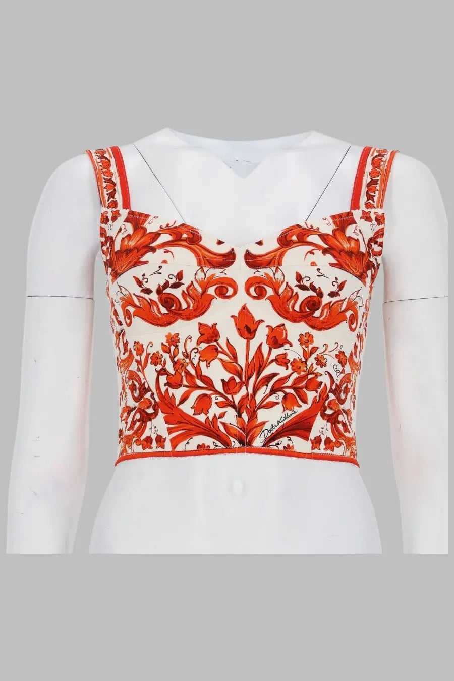 Dolce &amp; Gabbana women’s orange and white floral crop top bustier in charmeuse with baroque-inspired print on mannequin