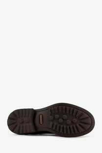 Back view of doucal’s men’s beatles leather boots gold showing dark brown rubber sole with hexagonal tread and douglas branding