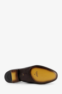 Doucal’s men’s daino leather loafers in dark brown with tan insole and black heel shown from the back side