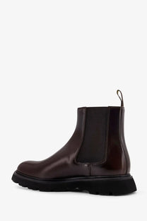 Doucal’s men’s dark brown patent leather chelsea boot with chunky black rubber sole and elastic side panels