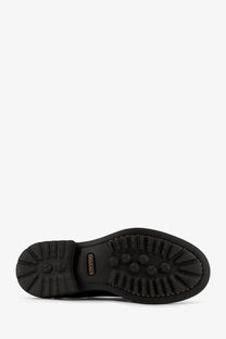 Back view of doucal’s men’s black leather boots with black rubber sole and hexagonal tread pattern on heel