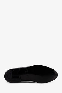 Black leather sole of Doucal’s men’s patent leather lace black shoe with glossy finish and visible edge stitching