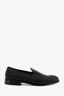 Doucal’s men’s black patent leather slip-on loafer with minimalist design and low-profile heel