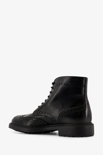 Doucal’s men’s triumph black leather brogue ankle boot with perforated detailing and chunky sole front view