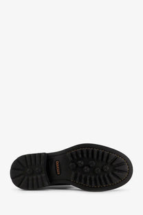 Black rubber sole with hexagonal tread and douglas branding on the heel of doucal’s men’s triumph leather ankle boots black back view