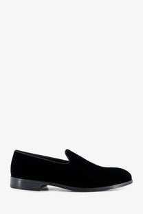 Doucal’s men’s black velvet slip-on loafers with sleek minimalist design and low-profile rubber soles