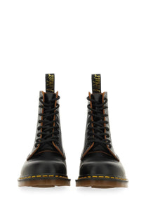 Black leather dr martens men’s boot vintage black showing the back side with classic stitching and heel loop