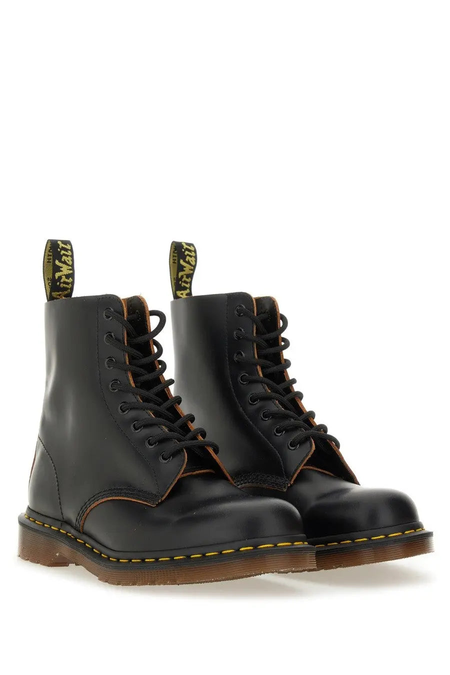 Dr martens men’s boot in vintage black leather showing the back side with classic stitching and heel loop