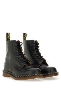 Dr martens men’s boot in vintage black leather showing the back side with classic stitching and heel loop