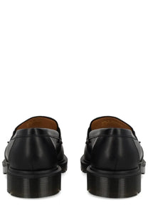 Black leather dr martens unisex mocassino delapre penny shoe showing the back side with classic design features