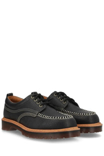 Black leather dr martens unisex mocassino lowell moc toe shoe showing front view with detailed stitching