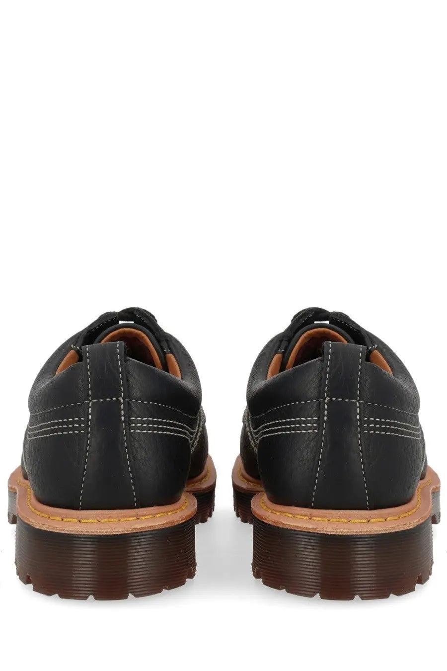 Black leather dr martens unisex mocassino lowell moc toe shoe showing the back side of the product