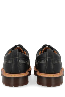 Black leather dr martens unisex mocassino lowell moc toe shoe showing the back side of the product