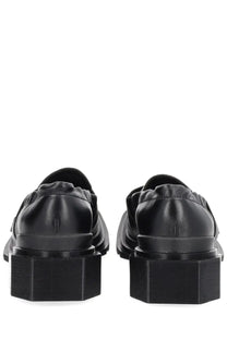 Dr martens women’s moccasin maybole black leather loafers with thick blocky soles shown from the back side