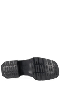 Black rubber sole with chunky block heel and textured tread on the back of dr martens women’s moccasin maybole black