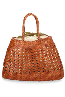 Tan woven straw tote bag with braided handles and drawstring closure by Dragon Diffusion in beige