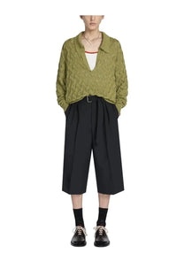 Olive green cable knit cardigan with collar and v neckline paired with dries van noten men’s black belted pants