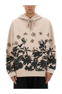 Dries van noten men’s cotton hoodie in beige with bold black and gray floral print elastic drawstring hood ribbed cuffs