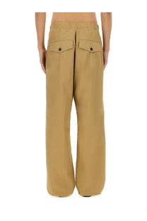 Dries Van Noten men’s beige cotton trousers with wide legs and tan flap pockets secured by black buttons
