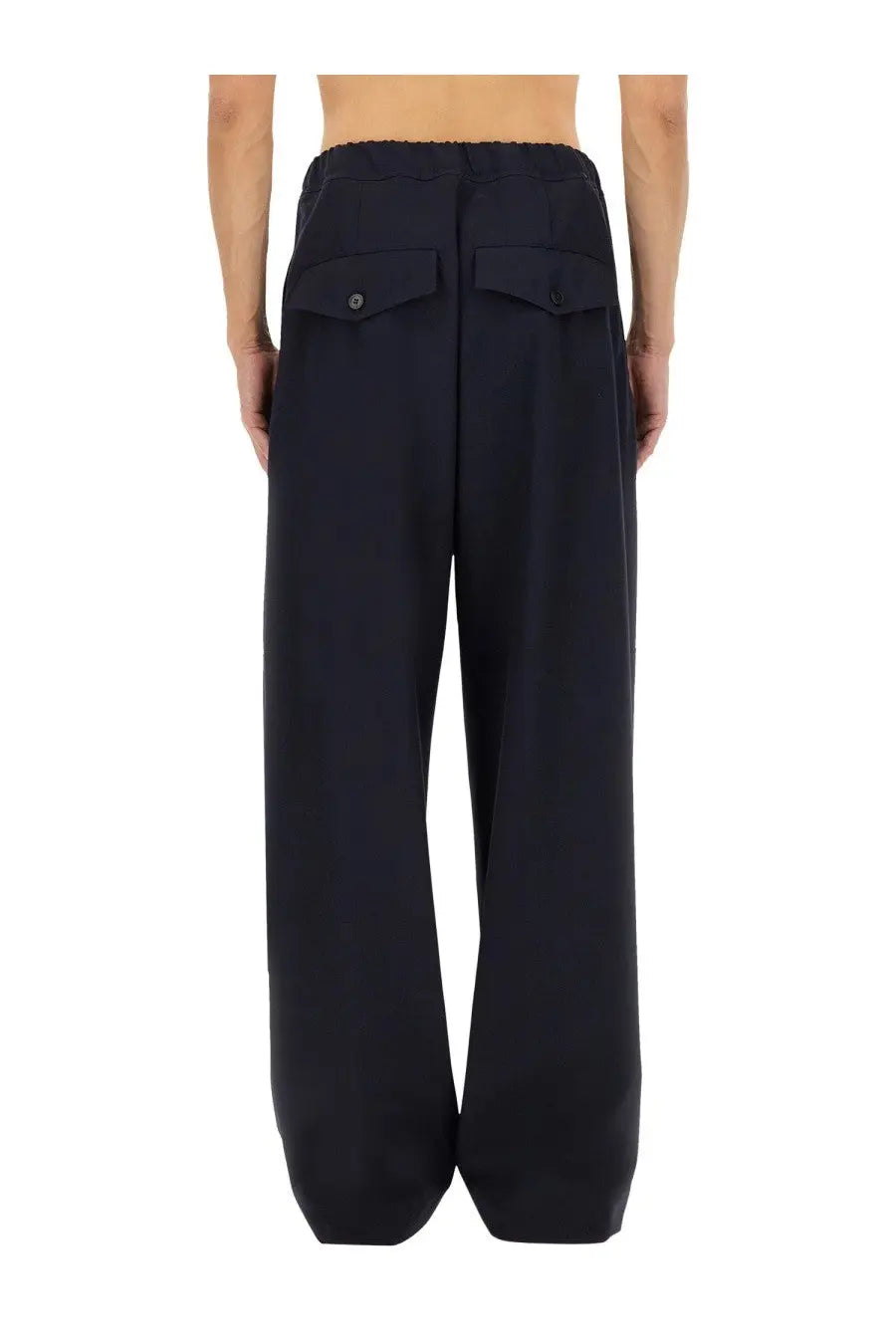 Black wide-leg cotton trousers with relaxed fit elastic waistband and buttoned front pockets for men by Dries Van Noten