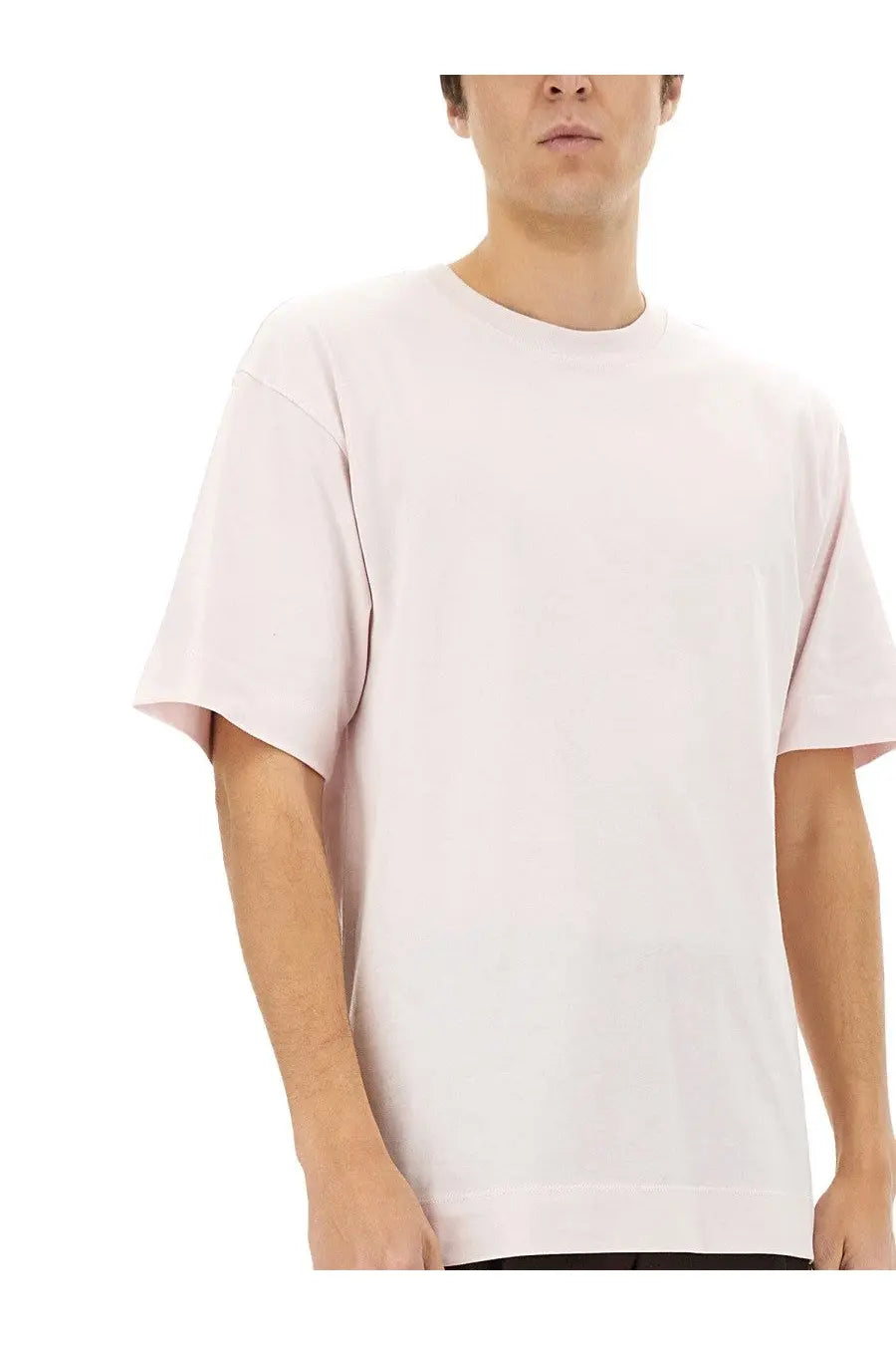 A soft blush pink oversized crewneck t-shirt made of smooth cotton fabric for men by dries van noten