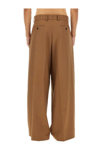 Brown wide-leg dries van noten men’s pants with tailored waistband and buttoned back pockets shown from the back