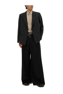 Black double-breasted blazer with tailored fit and classic notched lapels paired with dries van noten striped beige shirt