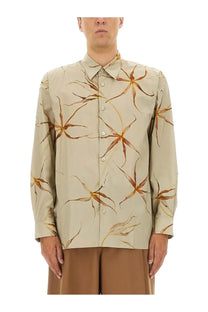 Beige long-sleeved button-up shirt with subtle warm brown and gold floral pattern by dries van noten