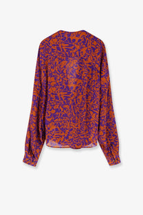 A flowing long-sleeved dries van noten women’s camiel cotton shirt in vibrant orange and purple abstract floral pattern