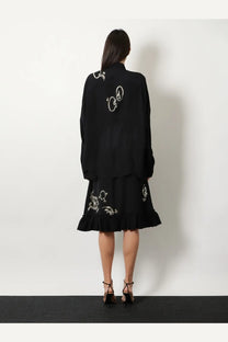 Dries Van Noten women’s Casia black long-sleeved dress with white embroidered floral patterns and ruffled hem
